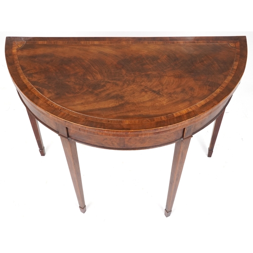 2041 - A late George III mahogany demi lune fold over card table raised on square tapering legs, 73cm H x 9... 