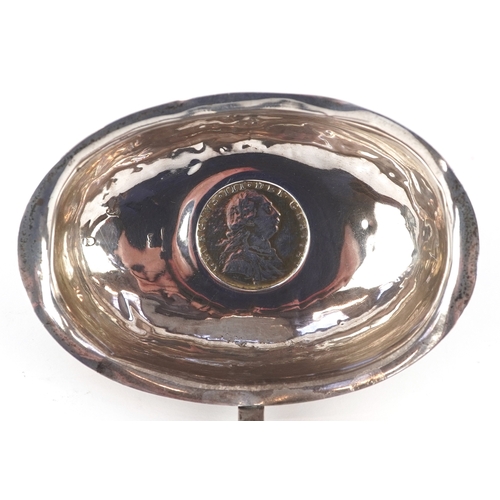 3642 - A George III silver ladle with twisted horn handle, the bowl set with a 1787 shilling, indistinct ha... 