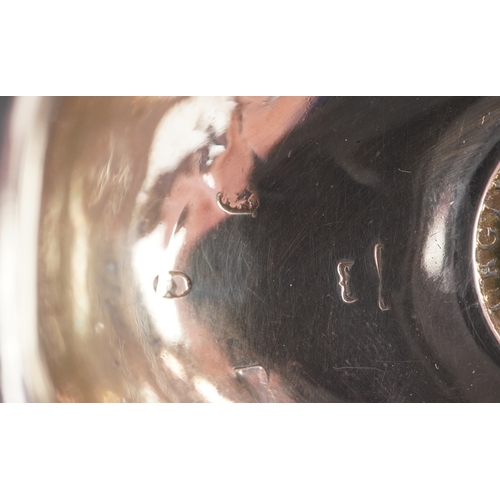 3642 - A George III silver ladle with twisted horn handle, the bowl set with a 1787 shilling, indistinct ha... 