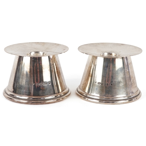 3572 - Trevor Towner, a pair of Arts & Crafts style silver candlesticks, London 2000, 5.5cm high, total 277... 