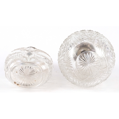 3610 - Two Victorian cut glass scent bottles with embossed silver lids, the largest 14cm high.