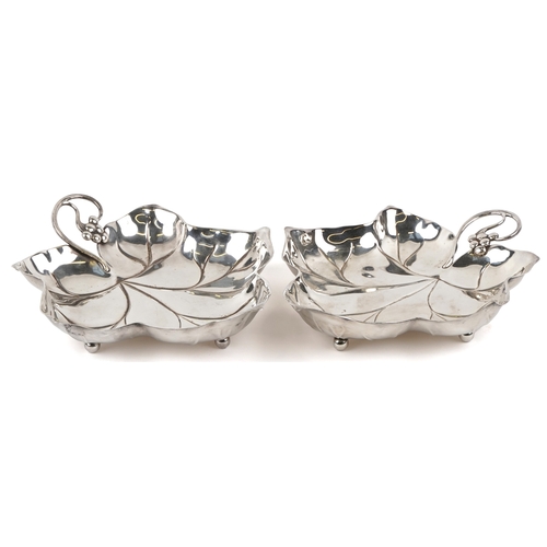 1652 - A pair of 20th century silver plated leaf dishes on ball feet, 25cm wide.