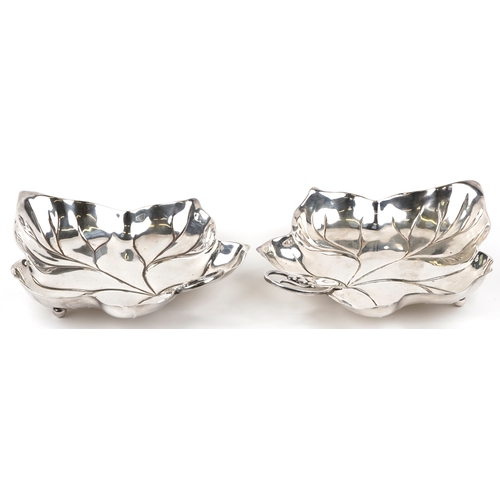 1652 - A pair of 20th century silver plated leaf dishes on ball feet, 25cm wide.