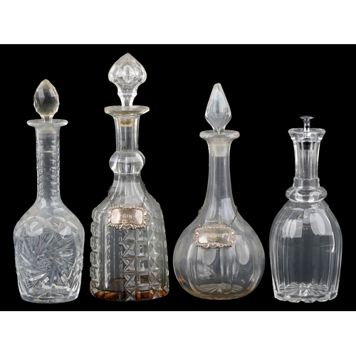 1714 - A group of four cut glass decanters and two silver decanter labels, the largest 35cm high
