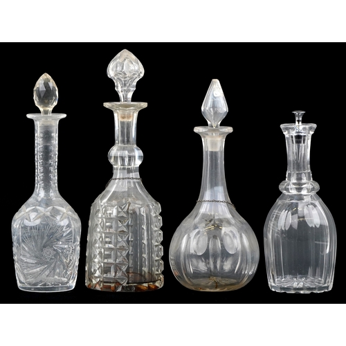 1714 - A group of four cut glass decanters and two silver decanter labels, the largest 35cm high