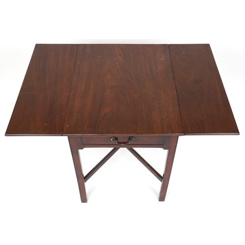 2037 - An late George III mahogany drop flap side table fitted with a drawer, raised on block legs united b... 