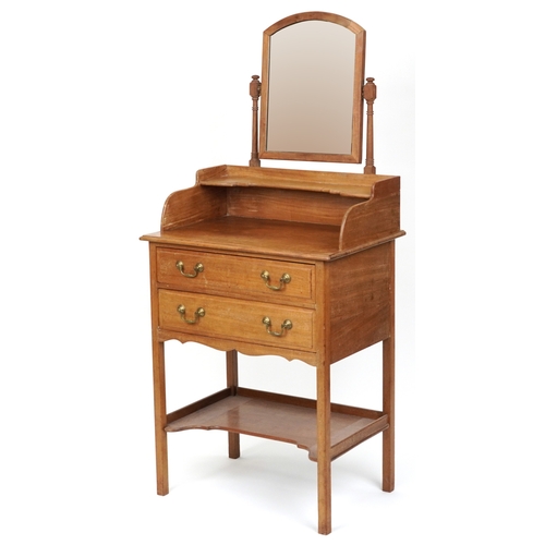 2078 - An early 20th century mahogany dressing chest fitted with a swing frame mirror above two drawers and... 