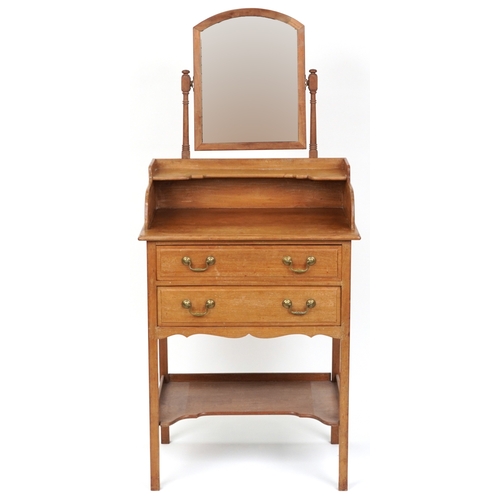 2078 - An early 20th century mahogany dressing chest fitted with a swing frame mirror above two drawers and... 