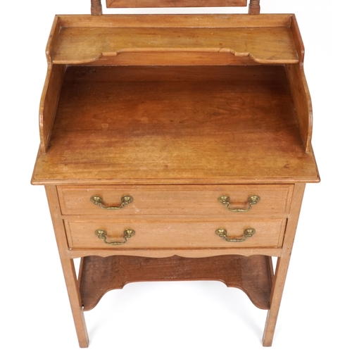 2078 - An early 20th century mahogany dressing chest fitted with a swing frame mirror above two drawers and... 