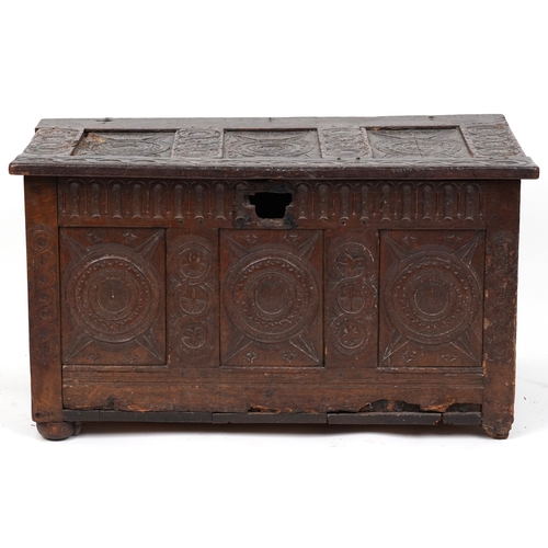 2016 - A 17th century oak triple panel coffer with carved decoration, the hinged lid above a linenfold frie... 