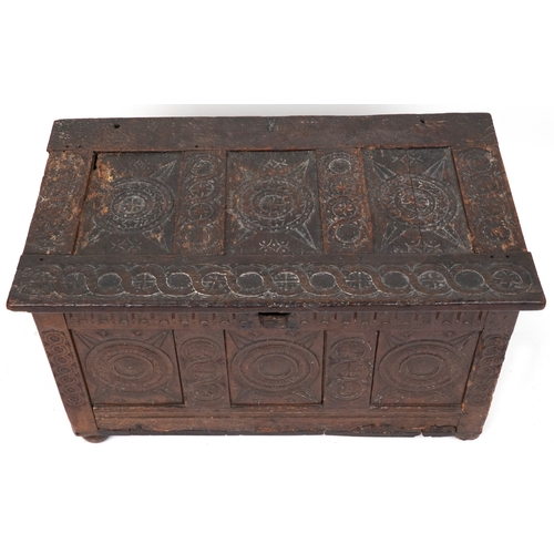 2016 - A 17th century oak triple panel coffer with carved decoration, the hinged lid above a linenfold frie... 