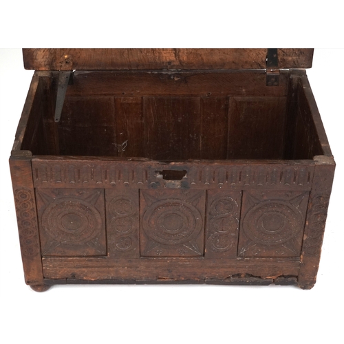 2016 - A 17th century oak triple panel coffer with carved decoration, the hinged lid above a linenfold frie... 