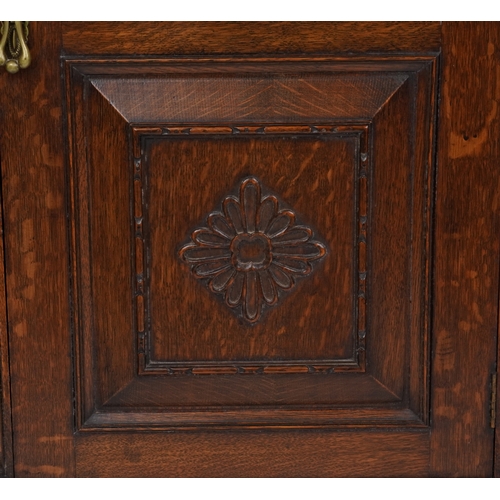 2079 - A late Victorian oak display cabinet, the carved central panel door flanked by two glazed cabinets, ... 