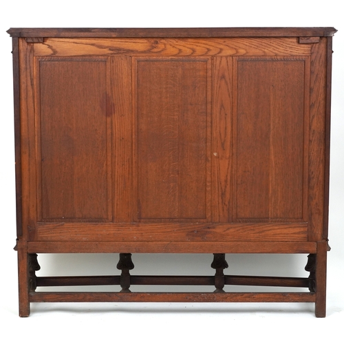2079 - A late Victorian oak display cabinet, the carved central panel door flanked by two glazed cabinets, ... 