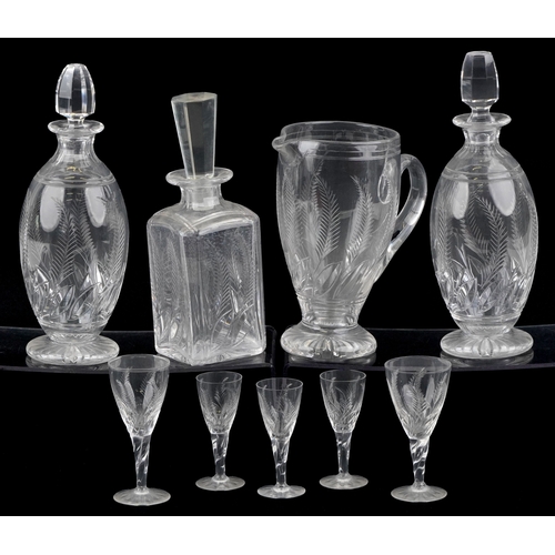 1729 - A collection of cut crystal glassware etched with leaves comprising three Stuart Crystal decanters a... 