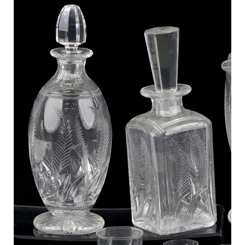 1729 - A collection of cut crystal glassware etched with leaves comprising three Stuart Crystal decanters a... 