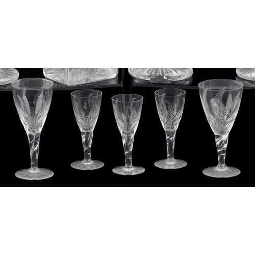 1729 - A collection of cut crystal glassware etched with leaves comprising three Stuart Crystal decanters a... 