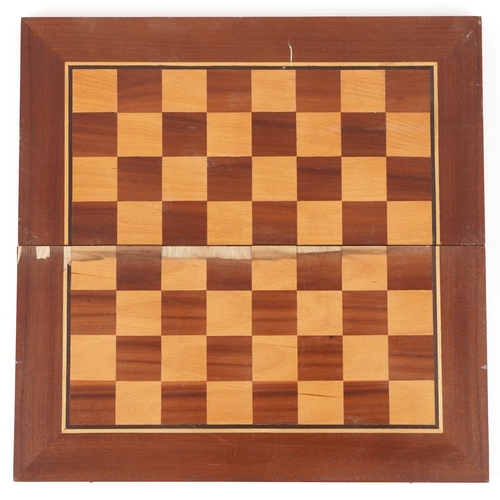 732 - A folk art hand painted wooden chess set with folding board, the largest piece 15cm high.