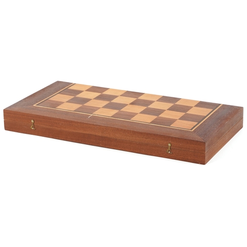 732 - A folk art hand painted wooden chess set with folding board, the largest piece 15cm high.