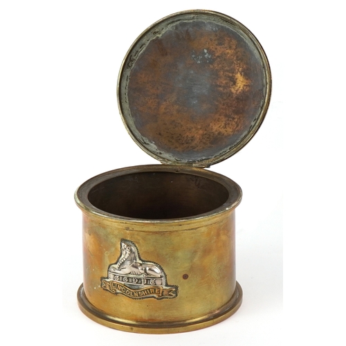 2807 - A British military World War I trench art tobacco box with hinged lid and Egypt Lincolnshire cap bad... 