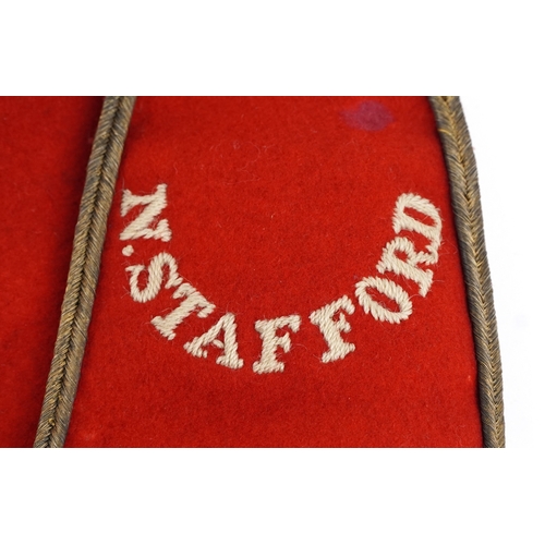 2765 - A British military North Staffordshire Regiment officer's dress tunic with N. Stafford epaulets.