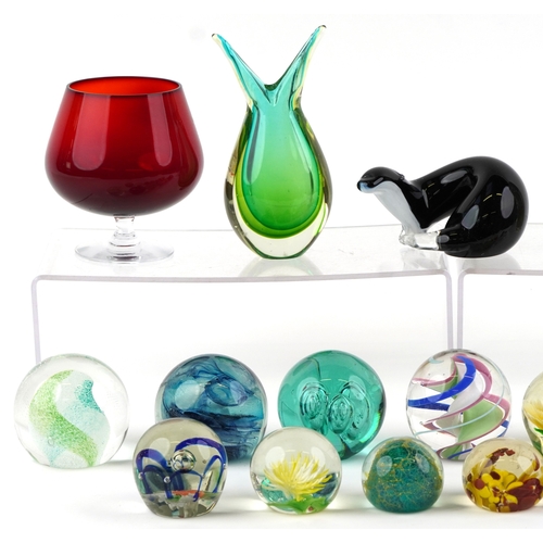 662 - A small collection of glass paperweights together with a glass model of an otter, a vase and an over... 