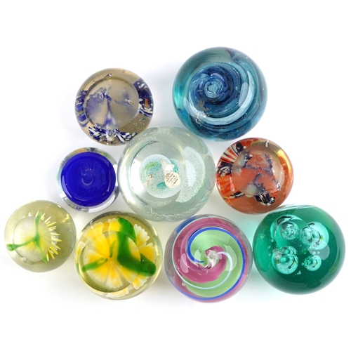 662 - A small collection of glass paperweights together with a glass model of an otter, a vase and an over... 