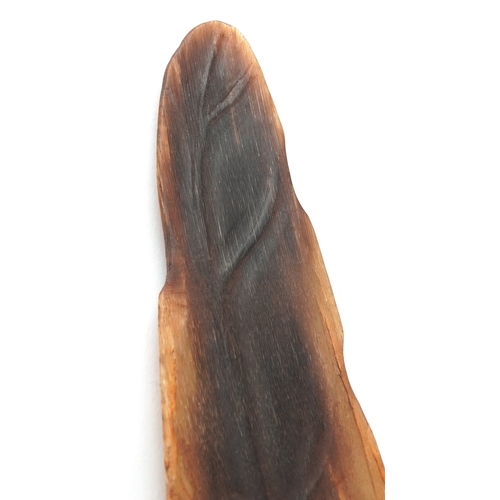 98 - A Chinese rhinoceros horn leaf shaped brush washer carved in relief to one side, pierced to the top ... 