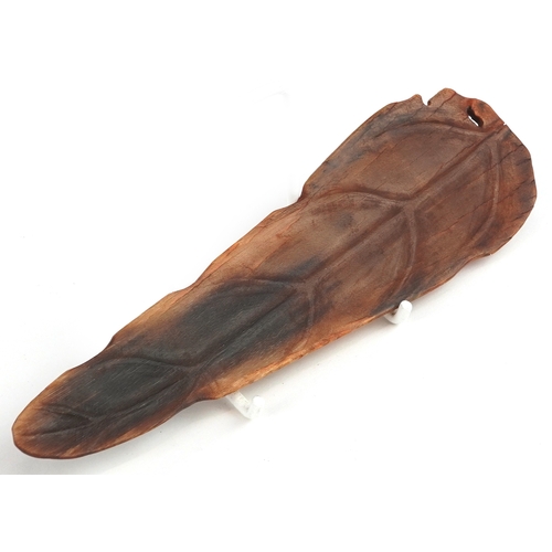 98 - A Chinese rhinoceros horn leaf shaped brush washer carved in relief to one side, pierced to the top ... 