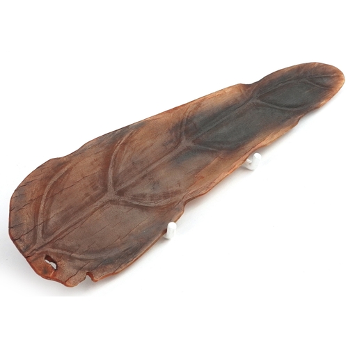 98 - A Chinese rhinoceros horn leaf shaped brush washer carved in relief to one side, pierced to the top ... 