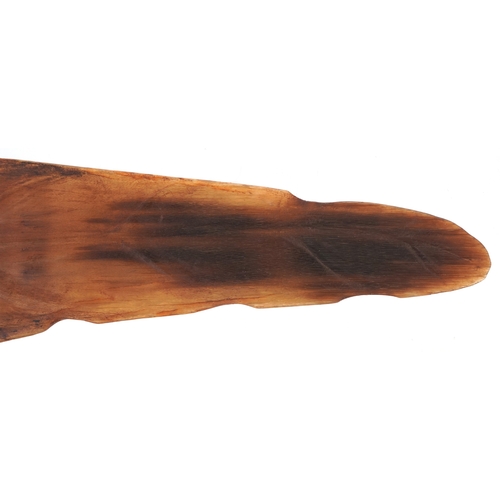 98 - A Chinese rhinoceros horn leaf shaped brush washer carved in relief to one side, pierced to the top ... 