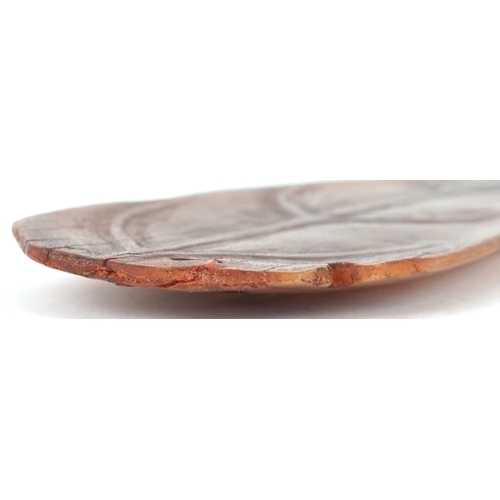 98 - A Chinese rhinoceros horn leaf shaped brush washer carved in relief to one side, pierced to the top ... 