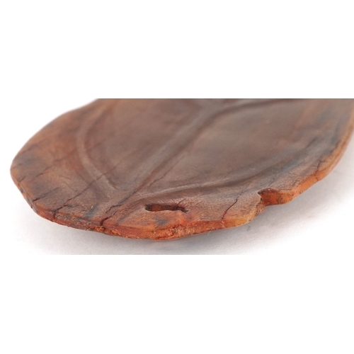 98 - A Chinese rhinoceros horn leaf shaped brush washer carved in relief to one side, pierced to the top ... 