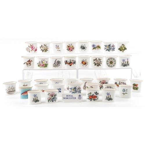 667 - A collection of Royal Worcester fine bone china cigarette holders, variously decorated, 7cm wide.