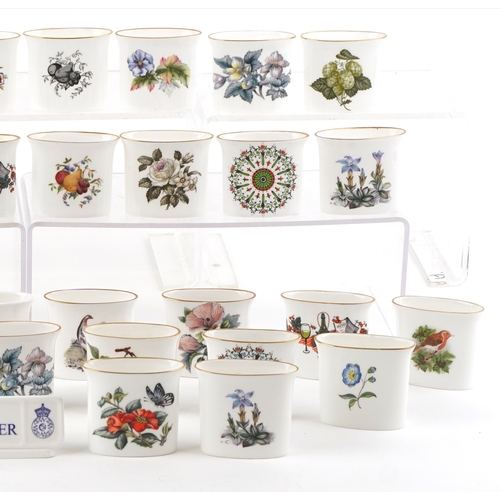 667 - A collection of Royal Worcester fine bone china cigarette holders, variously decorated, 7cm wide.