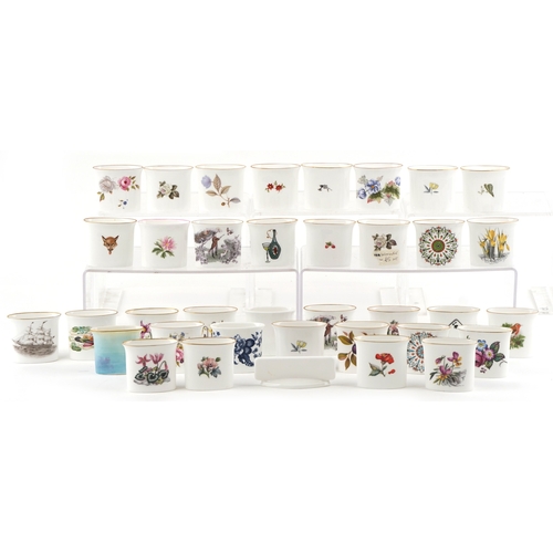 667 - A collection of Royal Worcester fine bone china cigarette holders, variously decorated, 7cm wide.