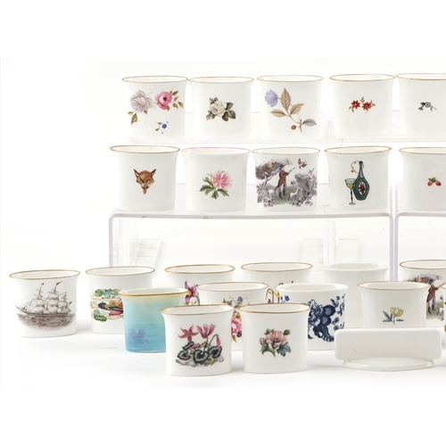 667 - A collection of Royal Worcester fine bone china cigarette holders, variously decorated, 7cm wide.