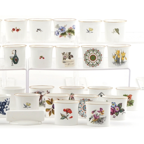 667 - A collection of Royal Worcester fine bone china cigarette holders, variously decorated, 7cm wide.