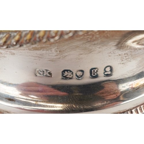 3569 - A George IV silver floral embossed cream jug raised on four ball feet, GK maker's mark, London 1822,... 