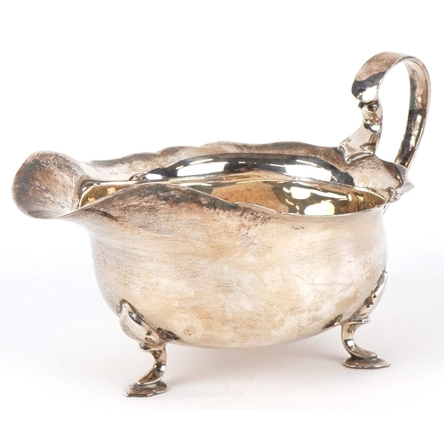 3607 - Mappin & Webb, a George V silver sauceboat raised on three feet, Sheffield 1935, 16cm in length, 113... 