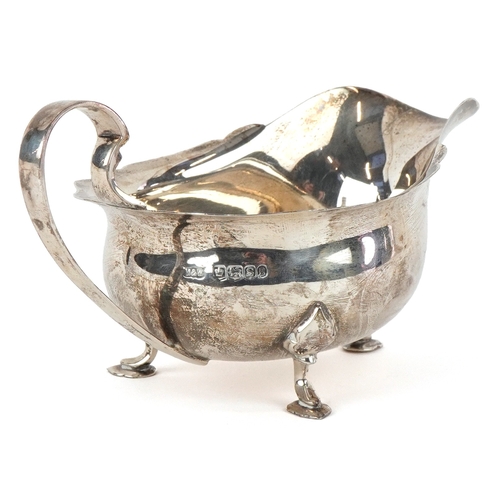 3607 - Mappin & Webb, a George V silver sauceboat raised on three feet, Sheffield 1935, 16cm in length, 113... 
