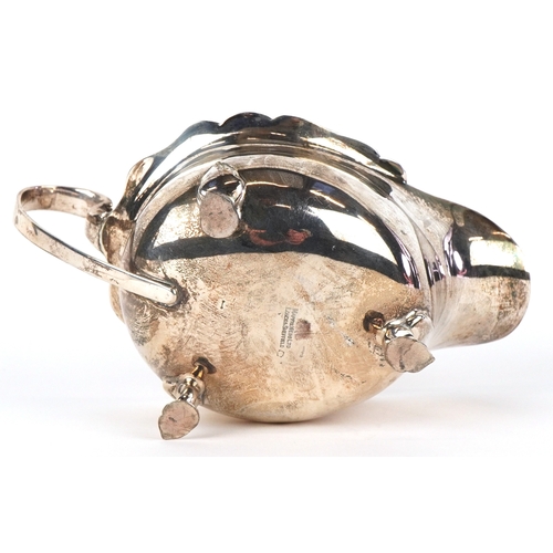 3607 - Mappin & Webb, a George V silver sauceboat raised on three feet, Sheffield 1935, 16cm in length, 113... 