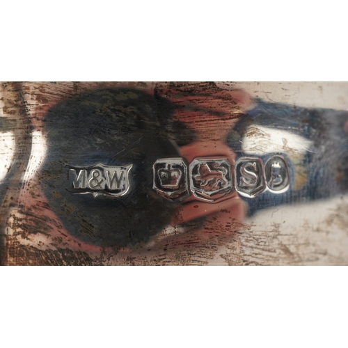 3607 - Mappin & Webb, a George V silver sauceboat raised on three feet, Sheffield 1935, 16cm in length, 113... 