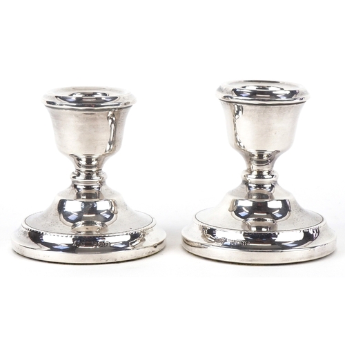 3677 - A T Cannon Ltd., a pair of Elizabeth II circular silver dwarf candlesticks, Birmingham 1973, 7cm hig... 