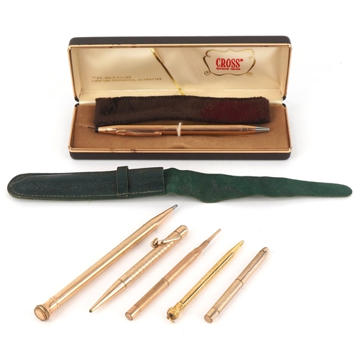 85 - Six gold plated and yellow metal propelling pencils, some with engine turned decoration including Cr... 