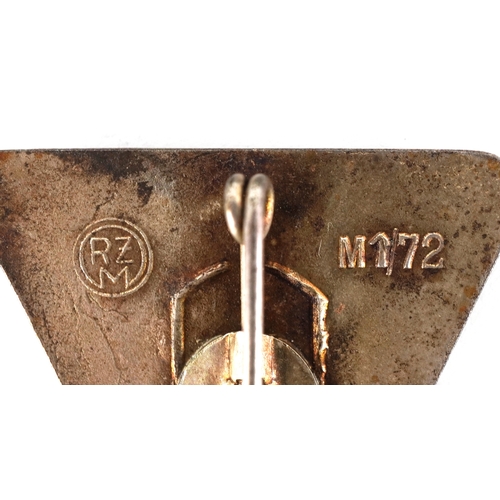 2743 - A collection of German military interest cap badges and pins etc