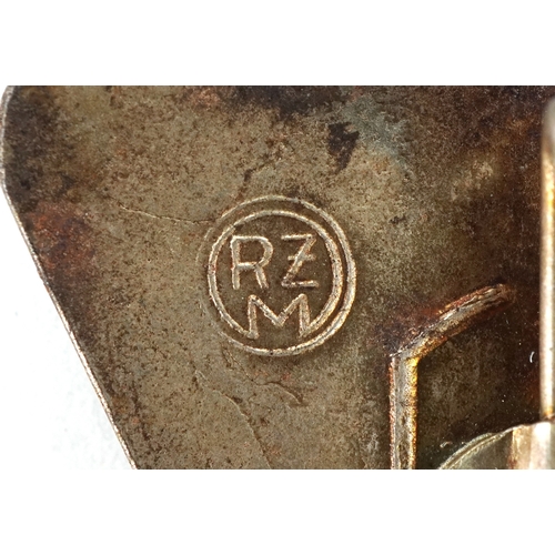 2743 - A collection of German military interest cap badges and pins etc