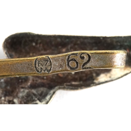 2743 - A collection of German military interest cap badges and pins etc