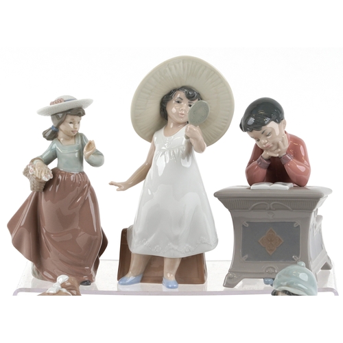 656 - Six Nao porcelain figures of young children including a boy at a desk, young girl with a teddy bear ... 