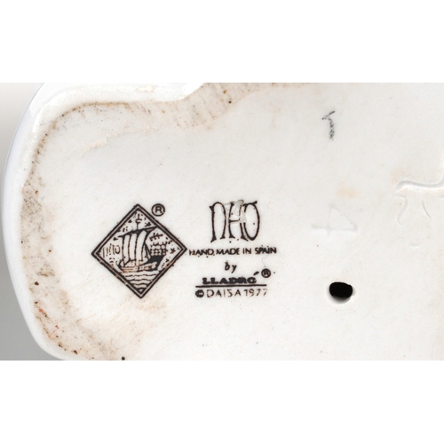 655 - Four Nao porcelain figures including a boy and girl in nightclothes, the largest 27cm high.